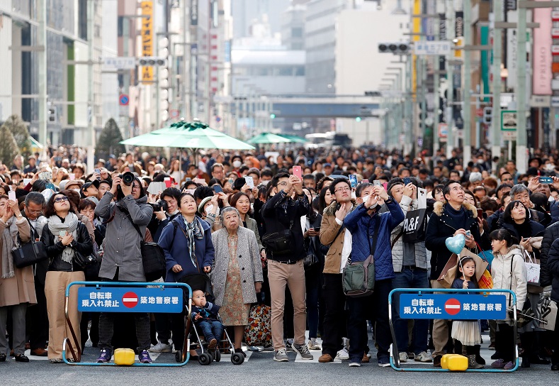 Participants face the clock tower as they hold a moment of silence at 2:46 p.m., the time when the magnitude 9.0 earthquake struck off Japan's coast in 2011, during a rally in Tokyo, Japan March 11, 2018.