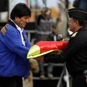 President Evo Morales hands a flag to Navy Commander Real Admiral Javier Ayllon during maritime flag day March 10.