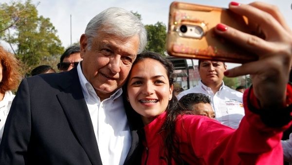 Andres Manuel Lopez Obrador, candidate of the National Regeneration Movement, takes a selfie after offering a floral tribute to the 80th anniversary of the expropriation of Mexico's oil industry at Lazaro Cardenas monument in Mexico City, March 18, 2018. 
