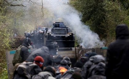 Protesters gather as French gendarmes advance with an armoured vehicle during clashes during an evacuation operation in the zoned ZAD.