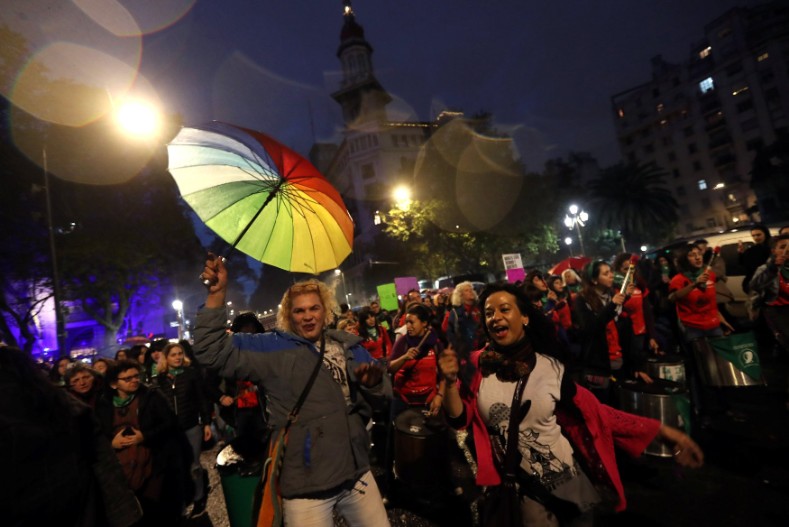 Demonstrators dance and shout slogans during a protest against femicides and violence against women in Buenos Aires.