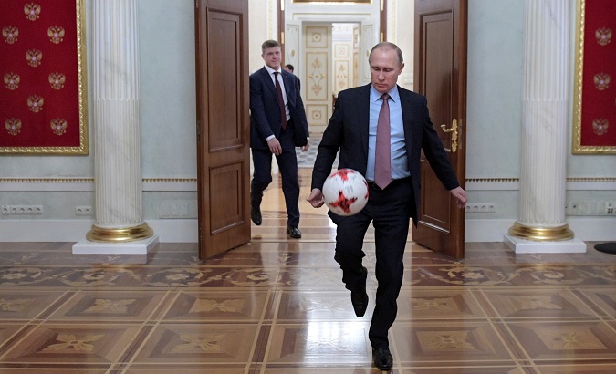 Russian President Vladimir Putin plays with a ball following a meeting with FIFA President Gianni Infantino at the Kremlin in Moscow, Russia.
