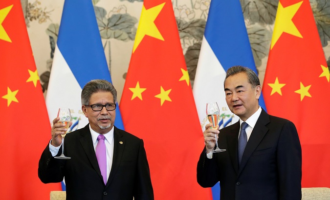 Chinese Foreign Minister Wang Yi and El Salvador's Foreign Minister Carlos Castaneda at ceremony to establish diplomatic ties.