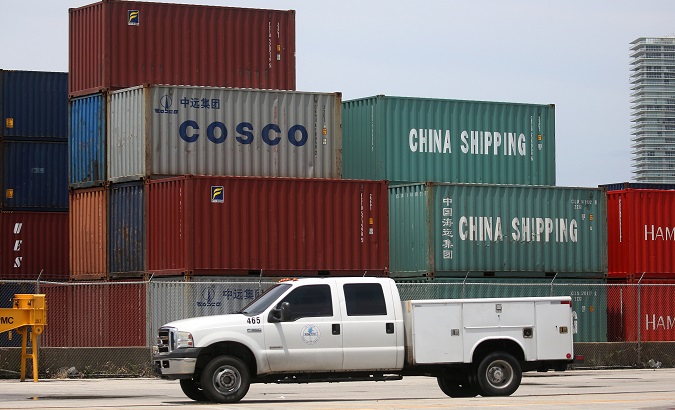 A truck drives past Cosco and China Shipping shipping containers in the Port of Miami in Miami, Florida, U.S., May 19, 2016.