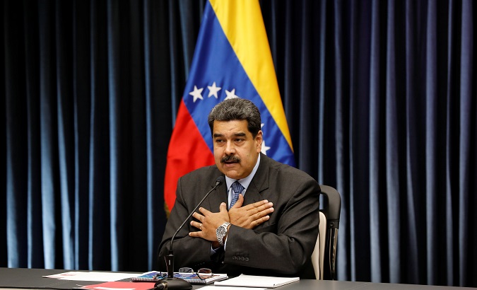 Venezuela's President Nicolas Maduro gestures as he talks to the media during a news conference at Miraflores Palace in Caracas, Venezuela, Sept. 18, 2018.