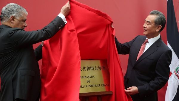 China's Foreign Minister Wang Yi and Dominican Republic's Chancellor Miguel Vargas unveil a plaque during the opening of a new Chinese Embassy in the Dominican Republic, in Santo Domingo, Dominican Republic Friday.
