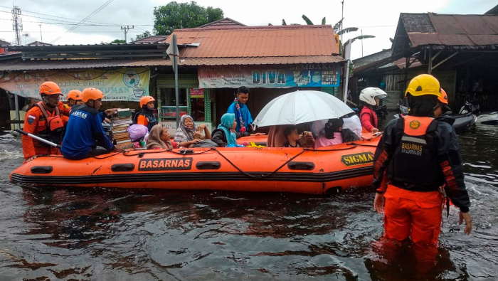 Rescatistas trasladan a personas de una zona residencial inundada en Kalimantan del Sur, Indonesia.