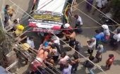 Ciudadanos y miembros de los servicios de emergencia asisten a un hombre herido por disparos de militares en Rangún, ciudad más grande del país.