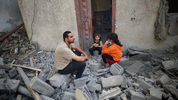 Father and their daughters in the ruins of Gaza, May 2024